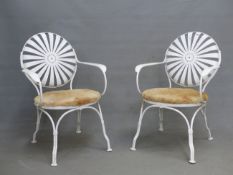 A PAIR OF FRANCOIS CARRE SPRUNG WHITE PAINTED IRON ELBOW CHAIRS WITH SUNBURST CIRCULAR BACKS AND