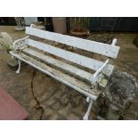 AN ANTIQUE GARDEN BENCH WITH CAST IRON END SUPPORTS.