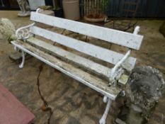 AN ANTIQUE GARDEN BENCH WITH CAST IRON END SUPPORTS.