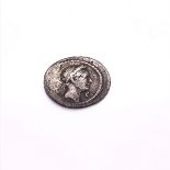 A JULIUS CAESAR SILVER DENARIUM FROM THE ROME MINT CIRCA BC 40 WITH A LAUREATE HEAD ON ONE SIDE