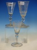 THREE 18th C. GERMAN WINE GLASSES, THE CONICAL BOWLS VARIOUSLY ENGRAVED WITH FLOWERS AND GEOMETRIC