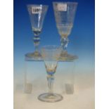 THREE 18th C. GERMAN WINE GLASSES, THE CONICAL BOWLS VARIOUSLY ENGRAVED WITH FLOWERS AND GEOMETRIC