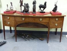 A GEORGE III MAHOGANY SIDEBOARD, THE BOW FRONT CROSS BANDED IN ROSEWOOD ABOVE TWO CENTRAL DRAWERS