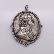A CHARLES 1st SILVER ROYALISTS BADGE WITH HIS PROFILE IN RELIEF ON ONE SIDE AND WITH HIS ROYAL