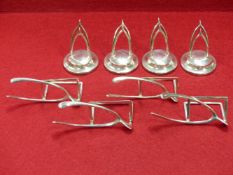 A SET OF FOUR HALLMARKED SILVER DOUBLE WISHBONE PLACE CARD HOLDERS WITH LOADED BASES FOR GEORGE