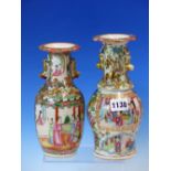 TWO 19th C. CANTON VASES VARIOUSLY PAINTED WITH FIGURE AND GARDEN FLOWERS BELOW GILT BUDDHIST LION