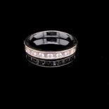 AN 750 STAMPED WHITE GOLD DIAMOND HALF ETERNITY RING. THE MIXED CUT DIAMONDS IN A CHANNEL SETTING.