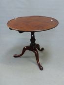 AN ANTIQUE MAHOGANY BIRD CAGE TRIPOD TABLE, THE DISHED CIRULAR TOP ON BALUSTER COLUMN, THE THREE