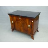 A BLACK MARBLE TOPPED MAHOGANY SIDE CABINET, THE COMPARTMENT DOOR WITH BRASS LION MASK AND RING