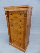 A 19th C. OAK WELLINGTON CHEST, THE SIX DRAWERS LOCKING BY A PILASTER HINGED TO ONE SIDE ABOVE THE