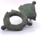 A ROMAN BRONZE BELT MOUNT, THE RING END ATTACHED TO ROUND ARCH SHOULDERS WITH BEADED ENDS AND