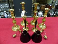 TWO PAIRS OF BRASS CANDLESTICKS. H 30.5 AND 26.5cms. TOGETHER WITH A MODERN PAIR OF BRASS TOPPED