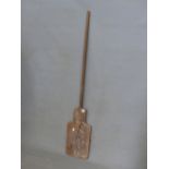 AN ANTIQUE WOODEN BREAD PADDLE.