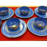 SIX BURMESE BLUE LACQUER BOWLS AND FIVE PLATES EACH GILT WITH LIONS WITHIN GILT RIM BANDS, THE