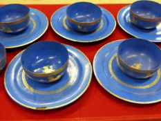 SIX BURMESE BLUE LACQUER BOWLS AND FIVE PLATES EACH GILT WITH LIONS WITHIN GILT RIM BANDS, THE