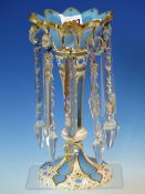 A BOHEMIAN WHITE OVERLAID SKY BLUE GLASS LUSTRE, THE WHITE GILT WITH FOLIAGE SCROLLS. H 25cms.