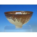 A DAVID FRITH BOWL, THE RIM OF THE CREAM GLAZED BODY BROWN WITH PENDANT DRIPS IN THE LUCIE RIE