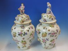 A PAIR OF FLORAL ENCRUSTED AND PAINTED HARD PASTE PORCELAIN VASES AND COVERS, ONE COVER SURMOUNTED