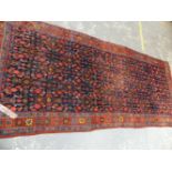 AN ANTIQUE PERSIAN BIDJAR RUG. 327 x 140cms.