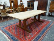 A PUGINESQUE OAK TABLE, THE RECTANGULAR TOP UNPOLISHED, THE POISHED ARCH SUPPORT JOINED TO TWIN