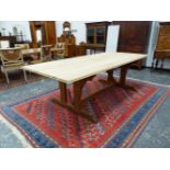 A PUGINESQUE OAK TABLE, THE RECTANGULAR TOP UNPOLISHED, THE POISHED ARCH SUPPORT JOINED TO TWIN