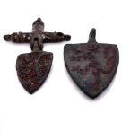 TWO MEDIAEVAL BRONZE SHIELD SHAPED PENDANTS WORKED WITH LIONS RAMPANT AGAINST RED ENAMELLED GROUNDS,