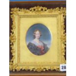 A VICTORIAN OVAL PORTRAIT MINIATURE OF A LADY WEARING A BLACK DRESS TIED WITH A RED RIBBON, THE