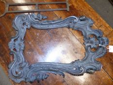 A ROCOCO TASTE BRONZE EASEL BACKED FRAME CAST WITH HEADS FLANKING THE ROCAILLE FOLIAGE CRESTING