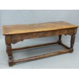 A 17th.C. AND LATER OAK REFECTORY TABLE WITH THREE PLANK TOP OVER CARVED FRIEZE, TURNED AND CARVED L