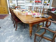 A VICTORIAN MAHOGANY EXTENDING DINING TABLE WITH TWO EXTENSION LEAVES, WITH TURNED LEGS AND LARGE