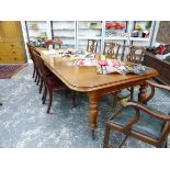 A VICTORIAN MAHOGANY EXTENDING DINING TABLE WITH TWO EXTENSION LEAVES, WITH TURNED LEGS AND LARGE