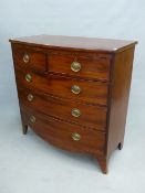 AN EARLY VICTORIAN MAHOGANY BOW FRONT CHEST OF TWO SHORT AND THREE LONG GRADUATED DRAWERS ON SPLAY