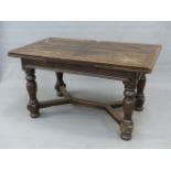 A 17th.C.STYLE OAK DRAW LEAF REFECTORY DINING TABLE ON TURNED SUPPORTS WITH CROSS STRETCHER. L.