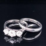 A PLATINUM AND DIAMOND THREE STONE DIAMOND RING SET WITH THREE GRADUATED BRILLIANT CUT DIAMONDS,