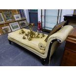 A REGENCY STYLE YELLOW UPHOLSTERED EBONISED CHAISE LONGUE, GILT BRASS ROSETTES APPLIED ABOVE THE