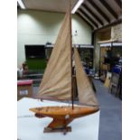 A LAMINATED WOOD POND YACHT HEATHER DEW FITTED WITH MAST JIB AND MAINSAIL, THE HULL WITH LEAD