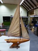 A LAMINATED WOOD POND YACHT HEATHER DEW FITTED WITH MAST JIB AND MAINSAIL, THE HULL WITH LEAD