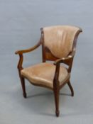 AN EDWARDIAN MAHOGANY ELBOW CHAIR THE LEATHER UPHOLSTERED BACK ABOVE FLORAL MARQUETRY, THE SERPENTIN