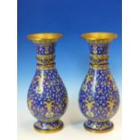 A PAIR OF CHINESE BLUE GROUND BALUSTER CLOISONNE VASES WITH WOOD STANDS, WHITE FLOWER BASED YELLOW