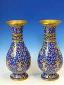 A PAIR OF CHINESE BLUE GROUND BALUSTER CLOISONNE VASES WITH WOOD STANDS, WHITE FLOWER BASED YELLOW