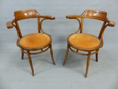 A PAIR OF THONET ELBOW CHAIRS, THE ROUND SEATS UPHOLSTERED IN DEEP TERRACOTTA CORDUROY