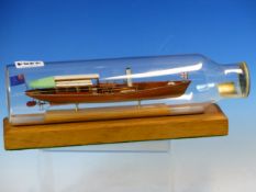 A WINDERMERE STEAMBOAT MUSEUM MODEL OF THE STEAM LAUNCH BRANKSOME MOUNTED WITHIN A BOTTLE ON A PLINT