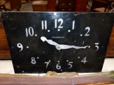 A VINTAGE BLACK PAINTED ALUMINIUM FACED RECTGULAR WALL CLOCK, THE METAL PIERCED THROUGH WITH