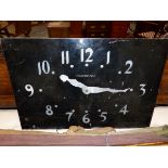 A VINTAGE BLACK PAINTED ALUMINIUM FACED RECTGULAR WALL CLOCK, THE METAL PIERCED THROUGH WITH