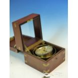 A WALTHAM WATCH Co. MARINE CHRONOMETER HOUSED IN BRASS GIMBALS WITHIN A MAHOGANY CASE. W 12.5 x D