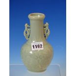 A CHINESE CELADON BOTTLE VASE WITH SEAHORSE SHAPED HANDLES, THE GLOBULAR BODY MOULDED IN RELIEF