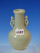 A CHINESE CELADON BOTTLE VASE WITH SEAHORSE SHAPED HANDLES, THE GLOBULAR BODY MOULDED IN RELIEF