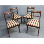 A SET OF FOUR REGENCY MAHOGANY DINING CHAIRS WITH ROPE RAIL BACK, DROP IN SEAT PADS ON SABRE