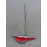 A SMALL RED AND BLUE HULL MODEL POND YACHT. L. 77cm.