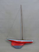 A SMALL RED AND BLUE HULL MODEL POND YACHT. L. 77cm.